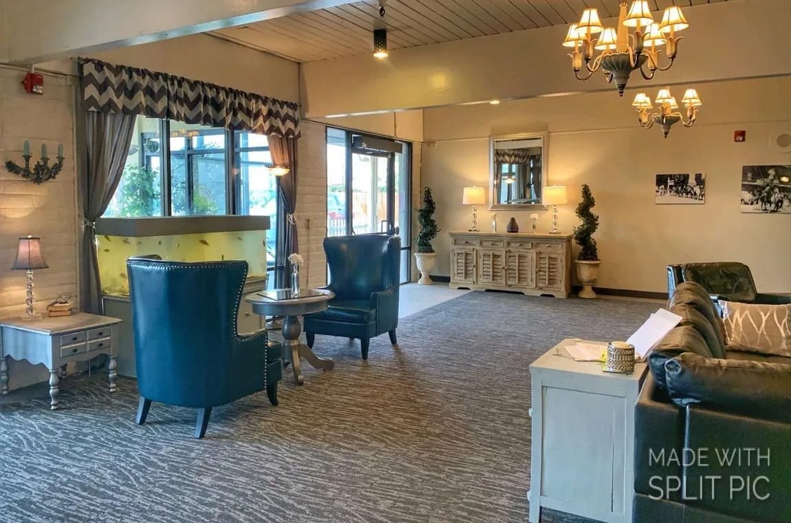 A living room with a lot of furniture and a chandelier.