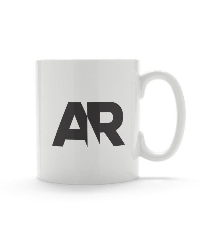 A white coffee mug with the letter ar on it