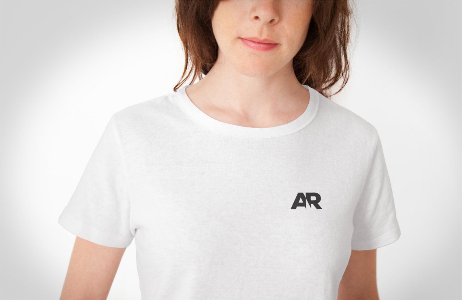 A woman wearing a white t-shirt with the letter ar on it
