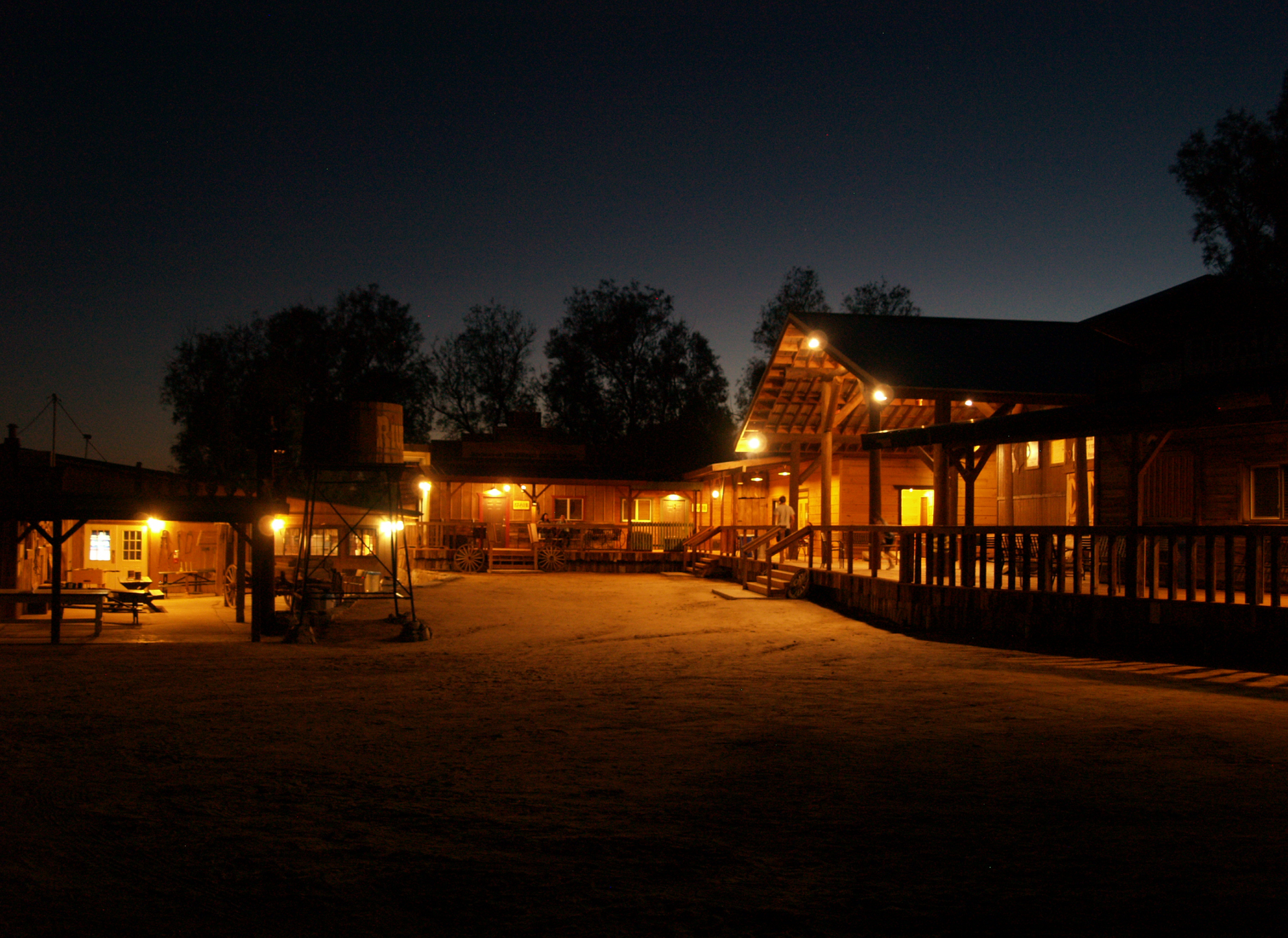 A group of buildings are lit up at night