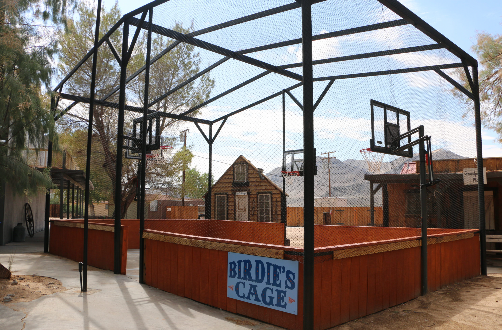 A basketball court with a sign that says birdie 's cage