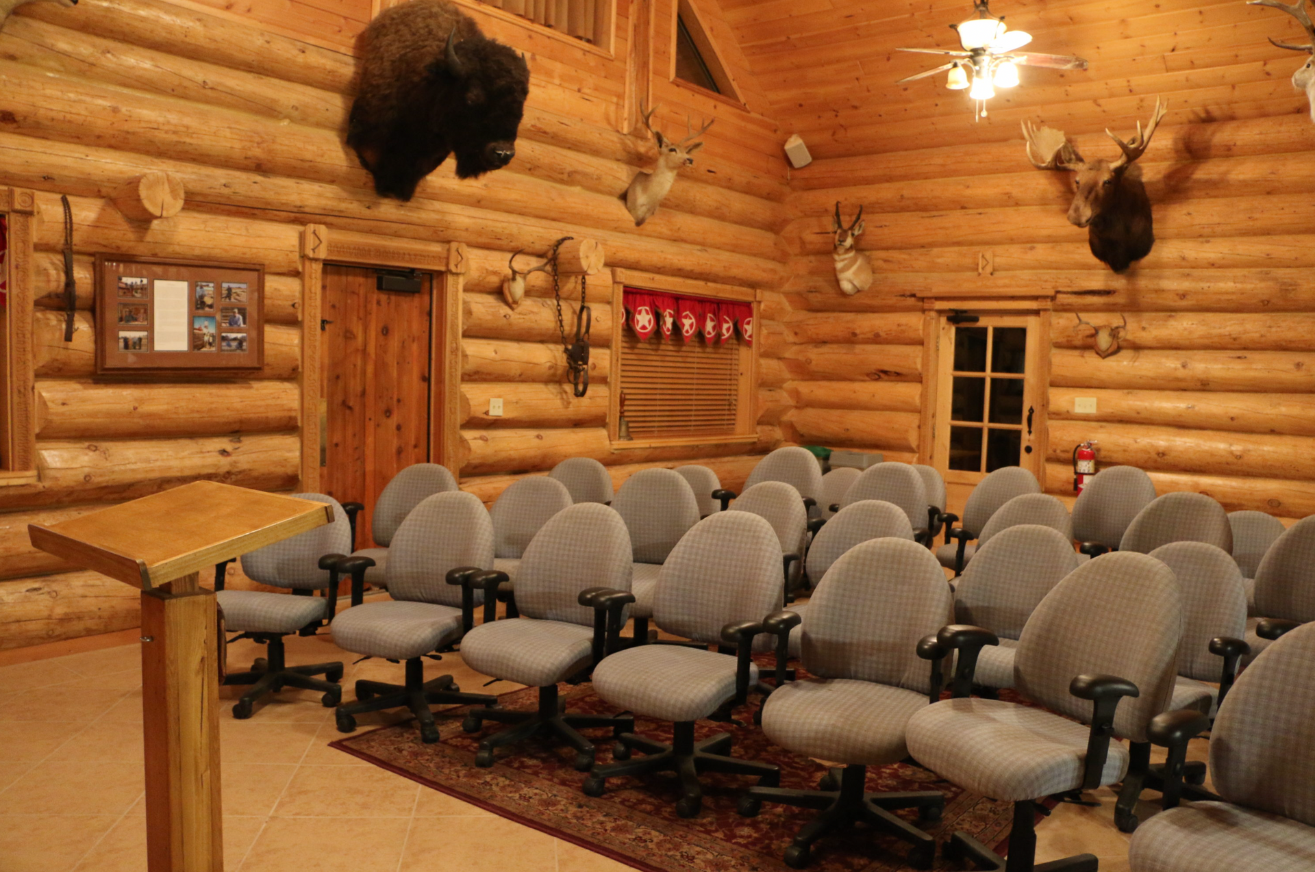A room with a lot of chairs and a podium in it