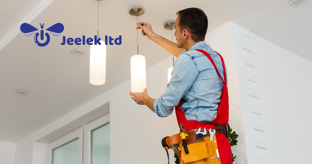 Electrical contractor fixing a ceiling lamp