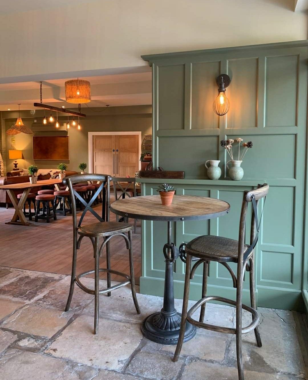 There is a table and chairs in the middle of the room.