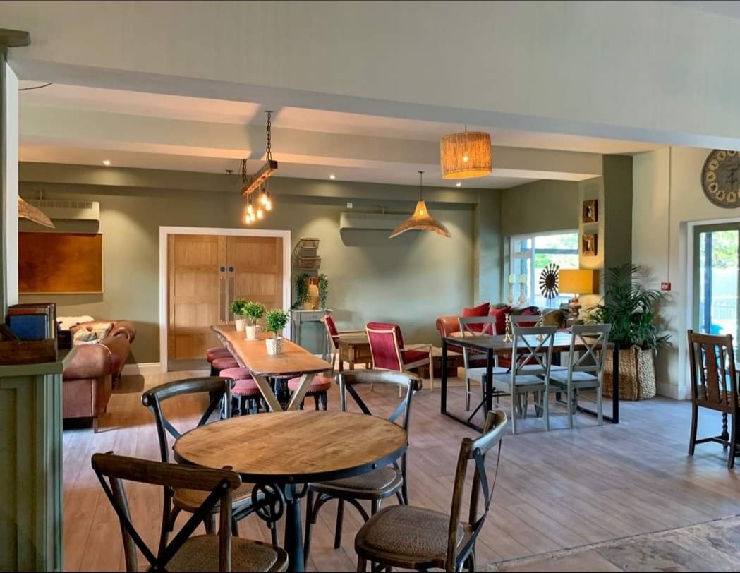 A restaurant with tables and chairs in a large room.