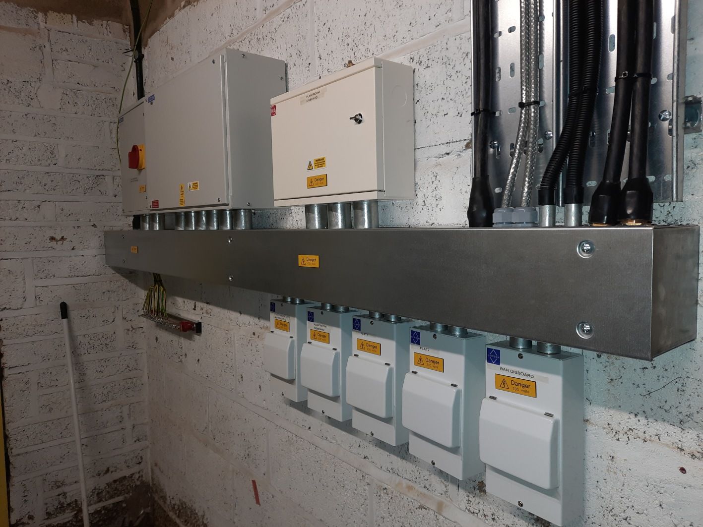 A wall with a bunch of electrical boxes on it