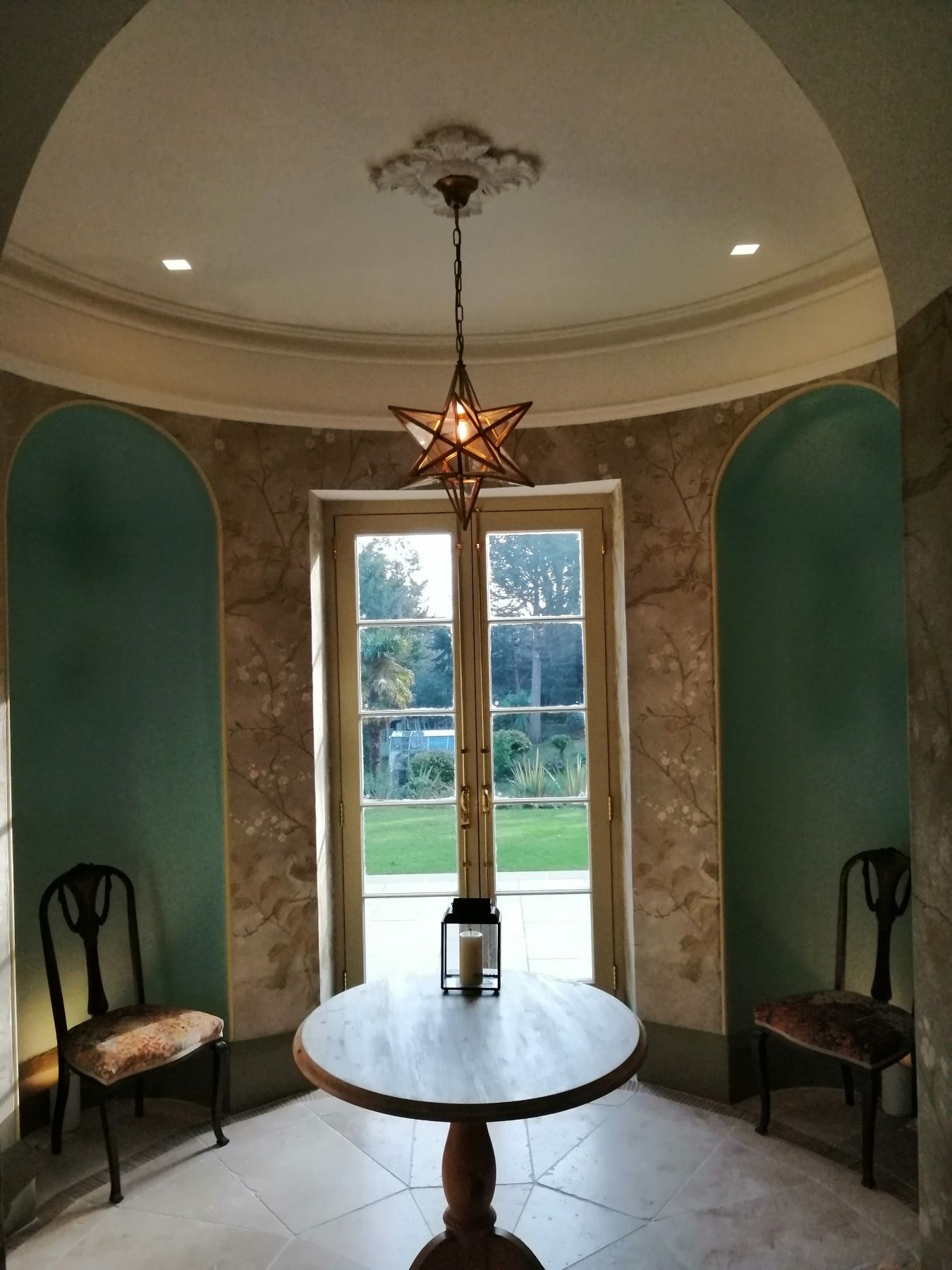 A round table with a star shaped light hanging from the ceiling