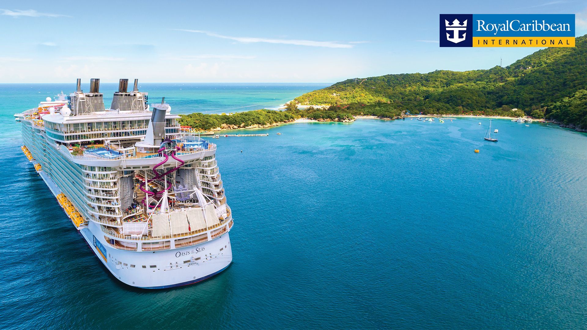Large cruise ship docked in a turquoise bay, lush green island in the background, Royal Caribbean logo.