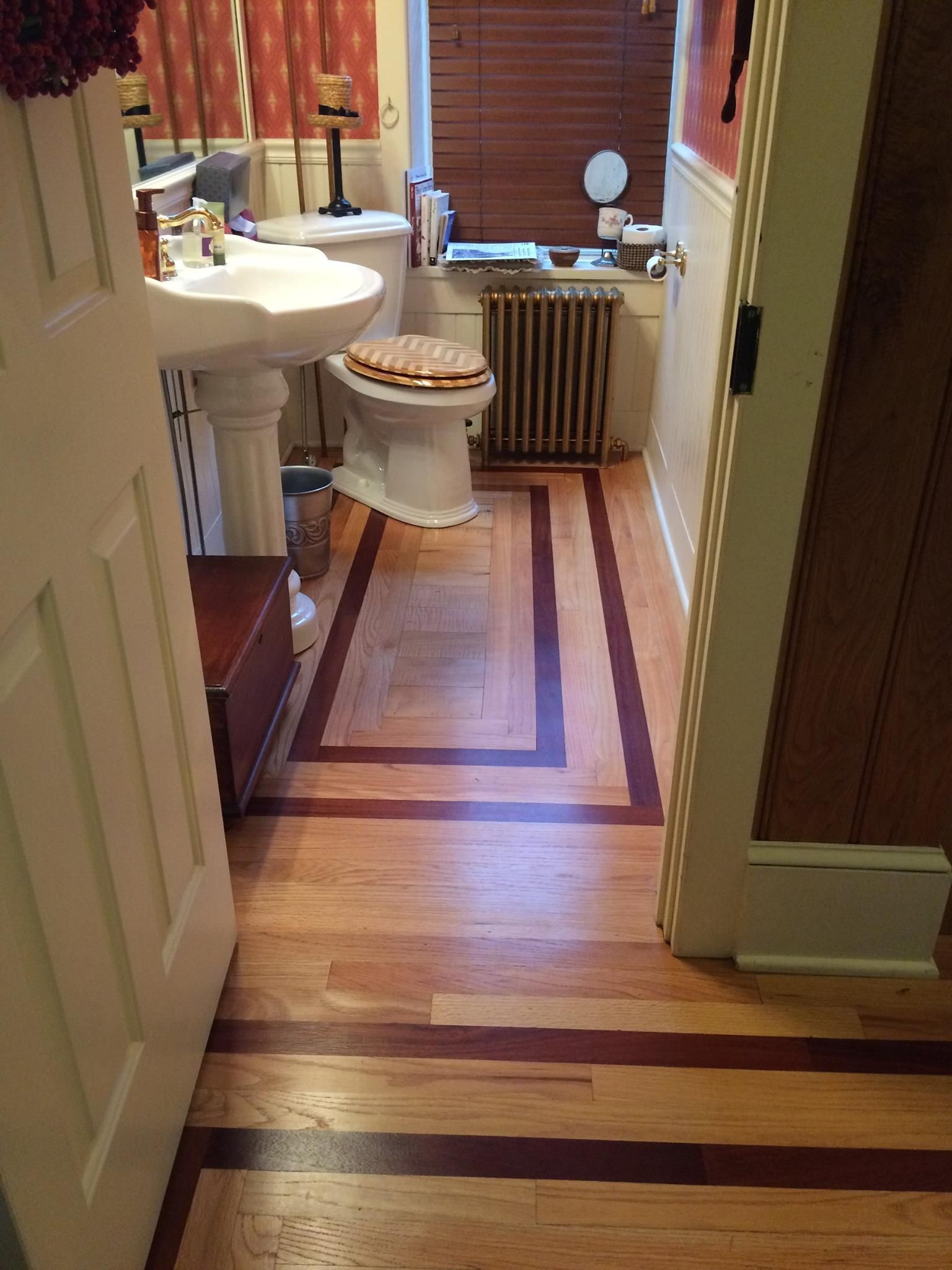 A bathroom with a toilet , sink , and radiator Galebach’s Floor Finishing