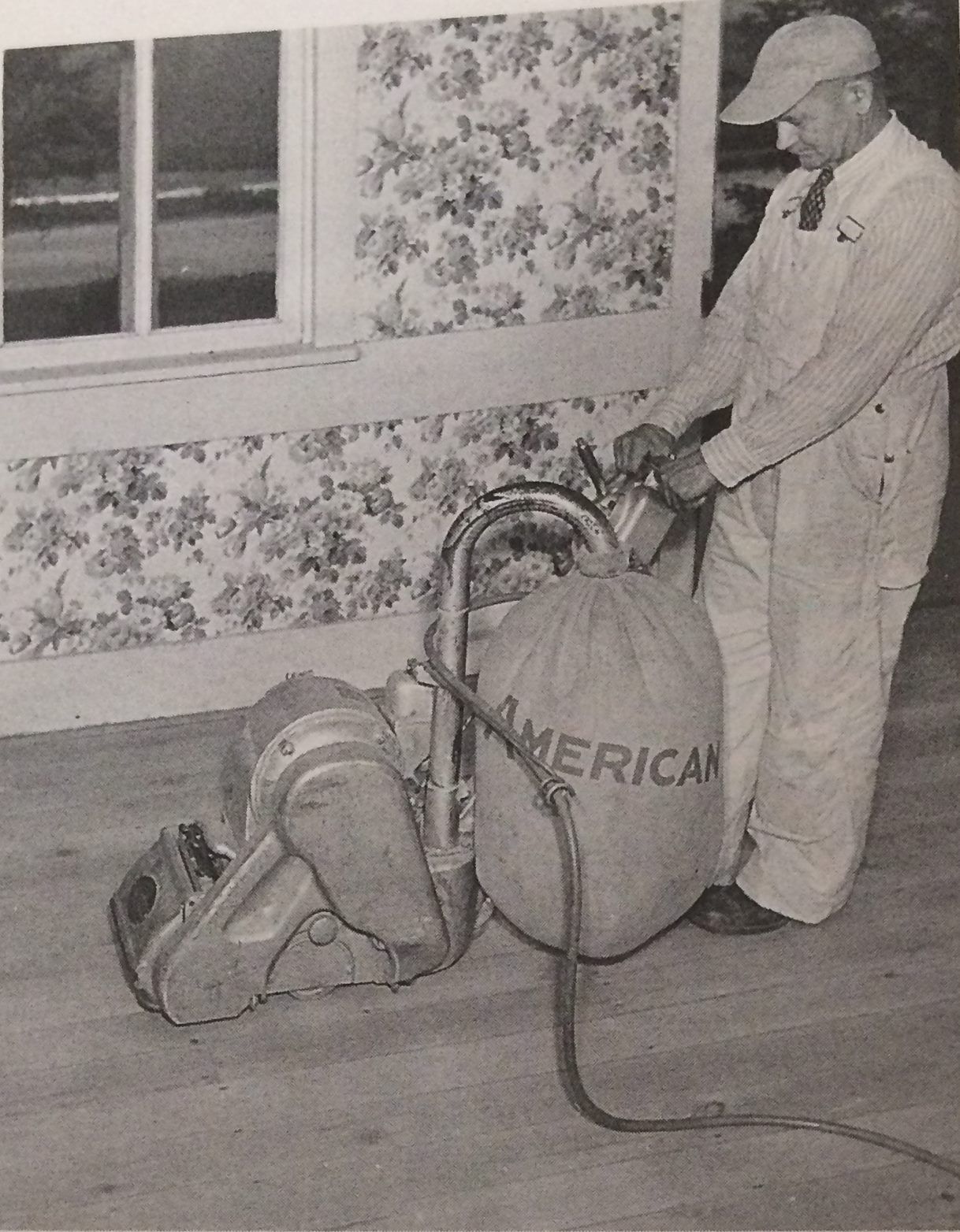 A black and white photo of a man using an american vacuum cleaner from Galebach’s Floor Finishing