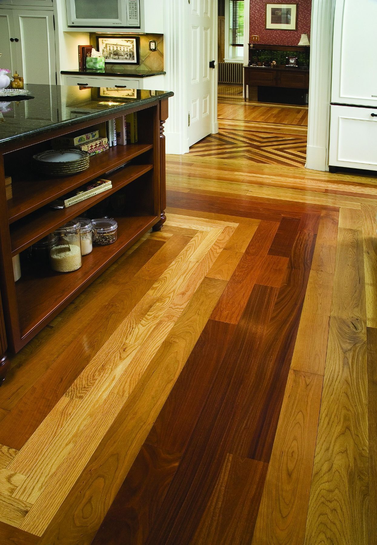 A kitchen with a wooden floor and a black counter top Galebach’s Floor Finishing