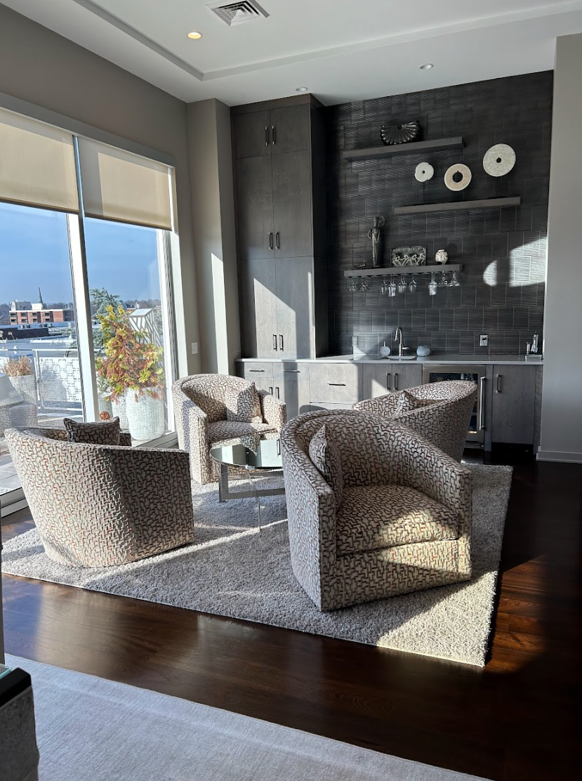 A living room filled with furniture and a large window.