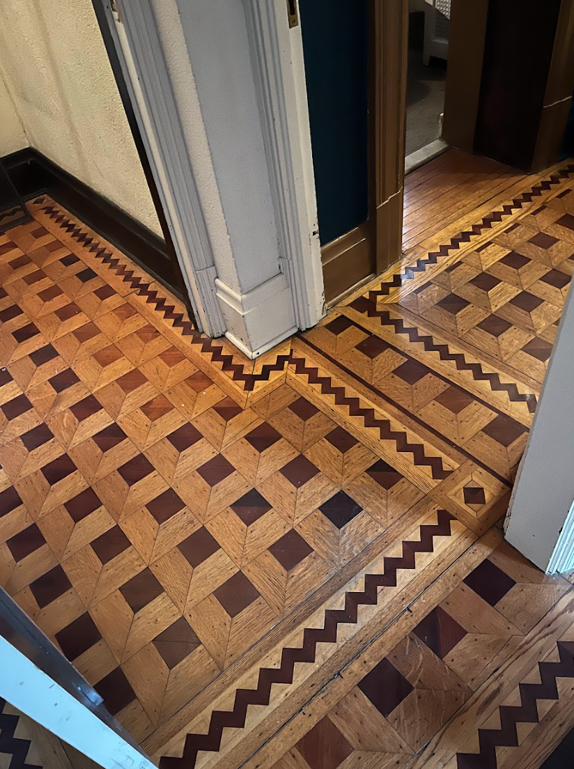 A wooden floor with squares and waves on it