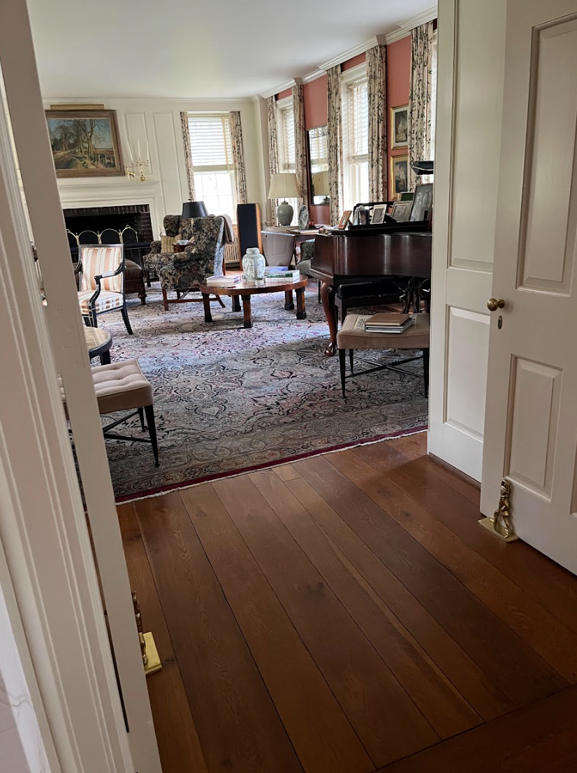 A living room filled with furniture and a piano.