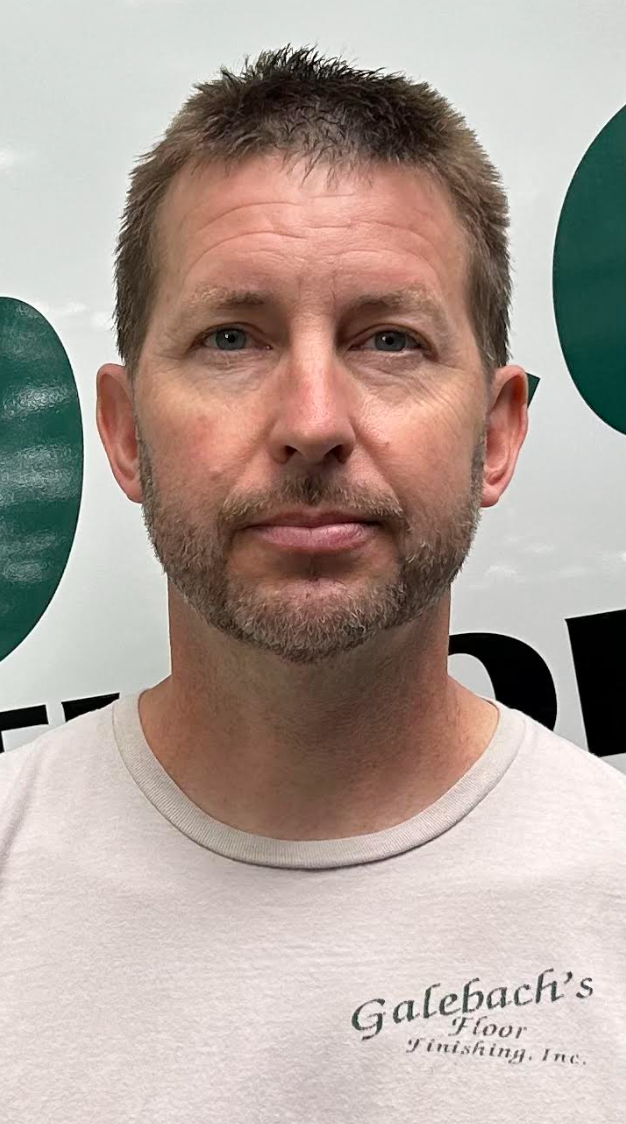 A man is wearing a green sweater and smiling Galebach’s Floor Finishing