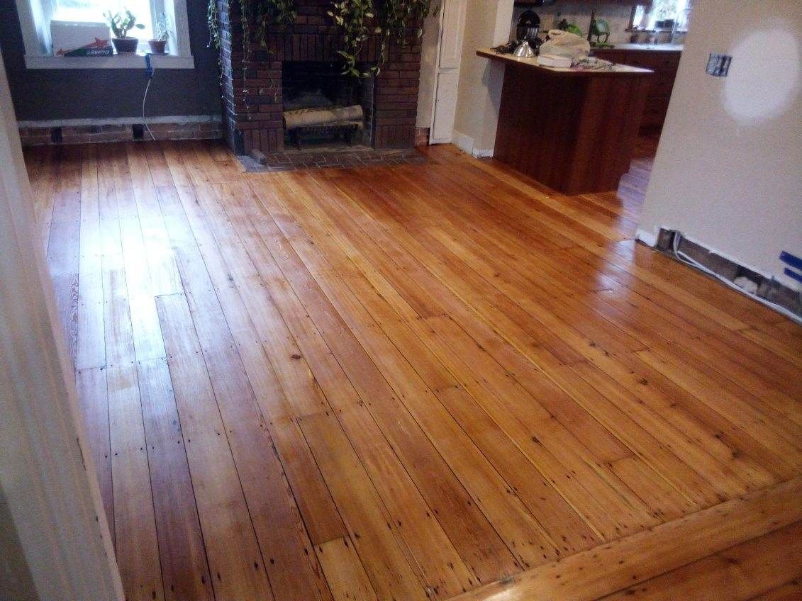 A living room with hardwood floors and a fireplace