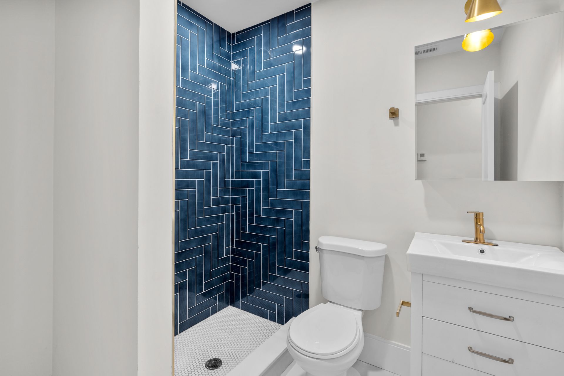 A bathroom with a toilet , sink , and shower.