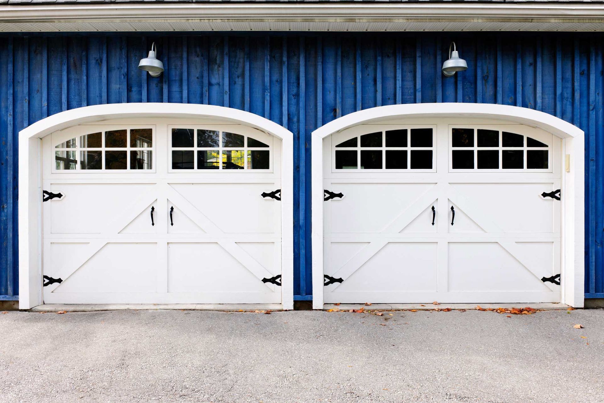 A view of double garage doors showcasing expert garage door repair durability. A view of double garage doors showcasing expert garage door repair durability.