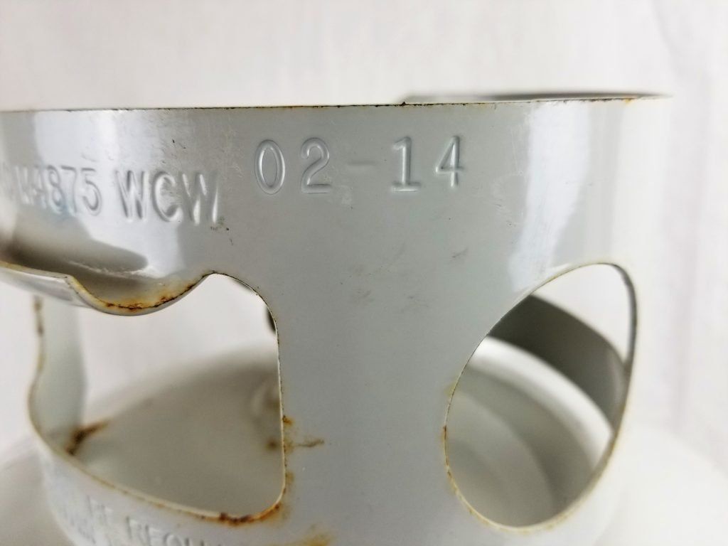 A close up of a metal object with the date 02-14 on it