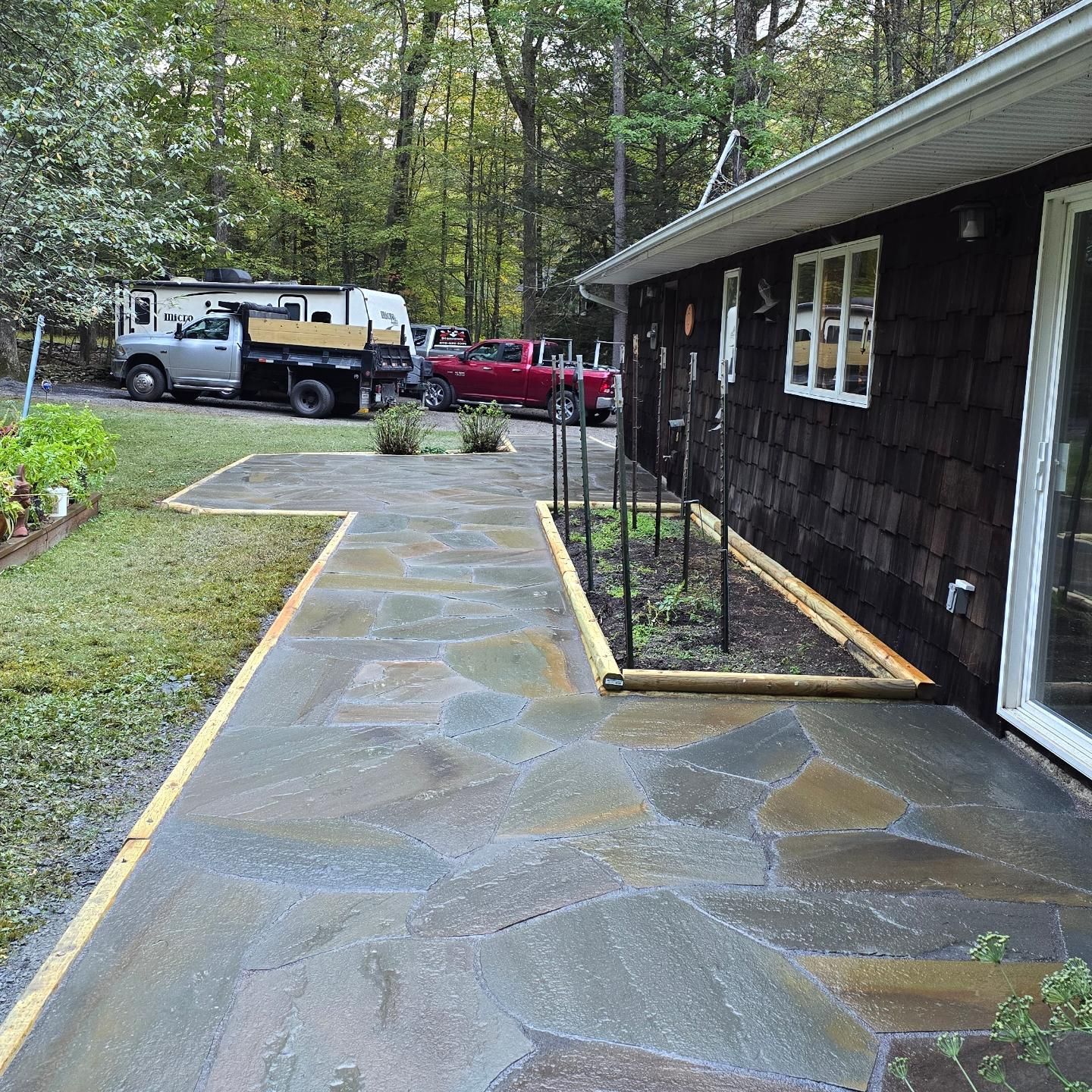 A red truck is parked in front of a house