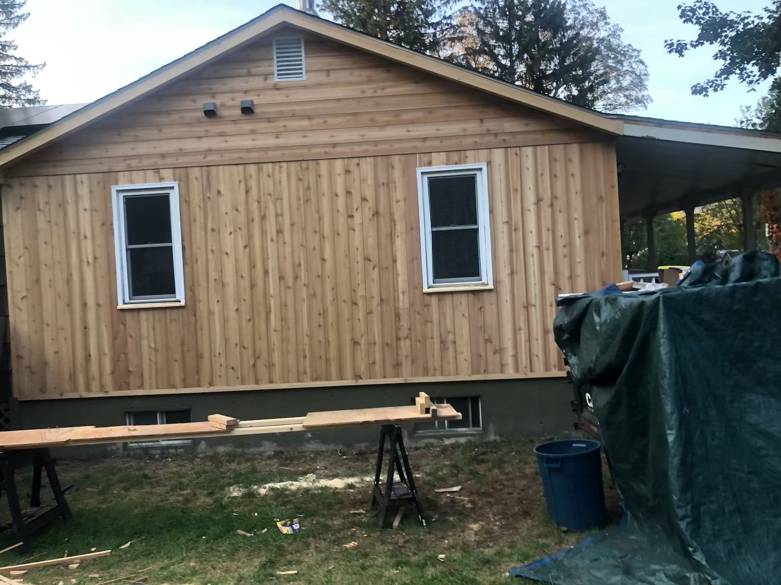 A house with a wooden siding and two windows