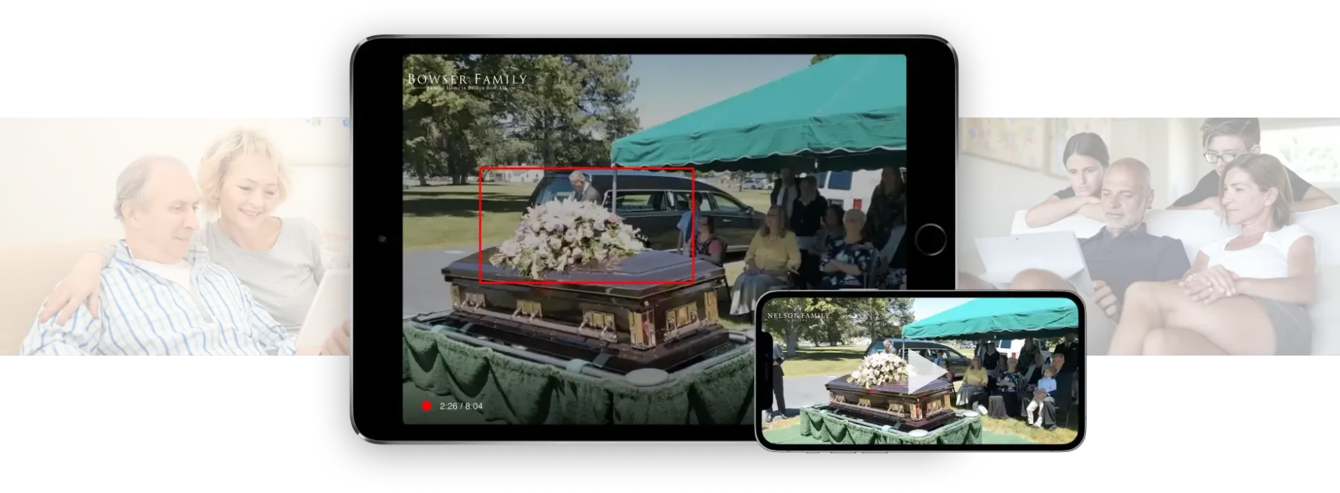 A tablet and smartphone displaying a video of an outdoor funeral service, with blurred people in the background.