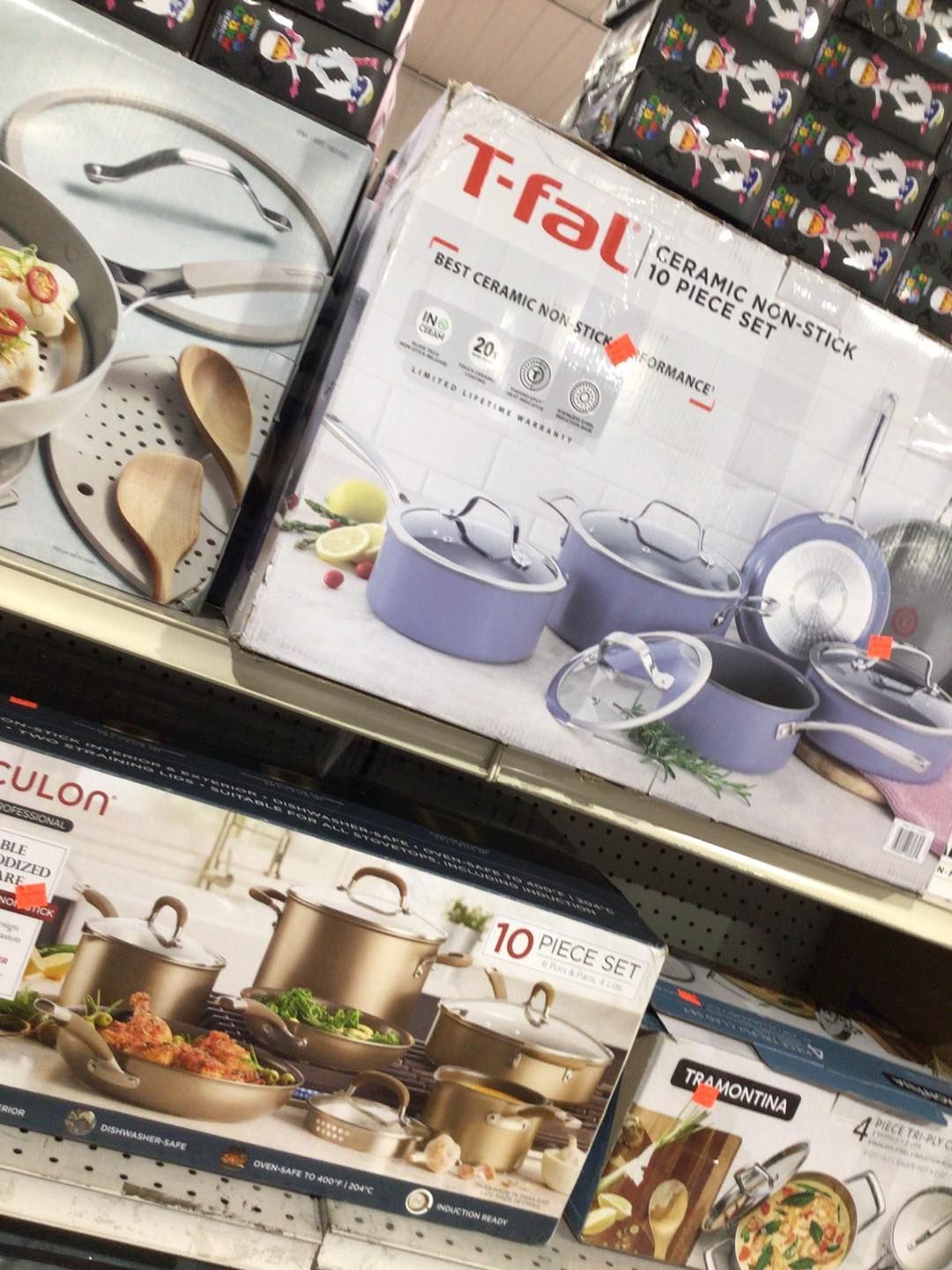 A bunch of pots and pans are stacked on top of each other on a shelf.