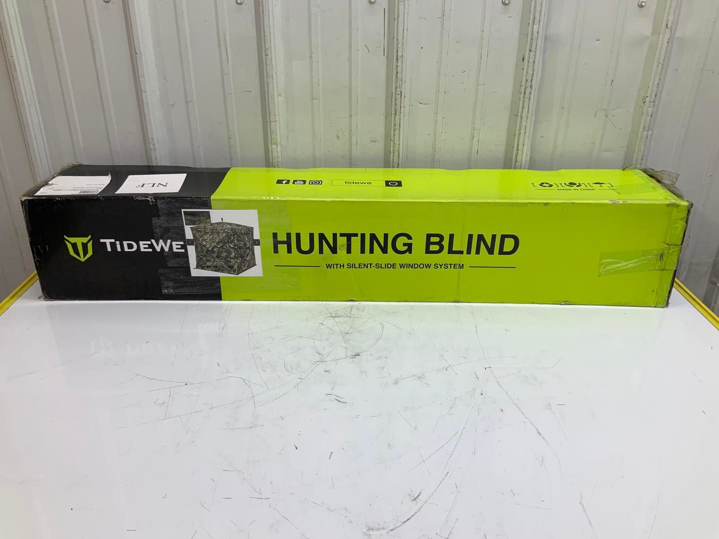 A hunting blind is sitting on top of a white table.