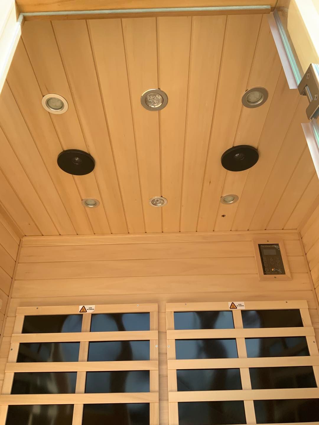 The ceiling of a sauna with a lot of lights on it