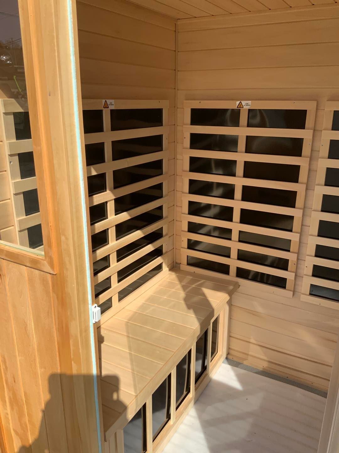 A wooden sauna with a bench and a window