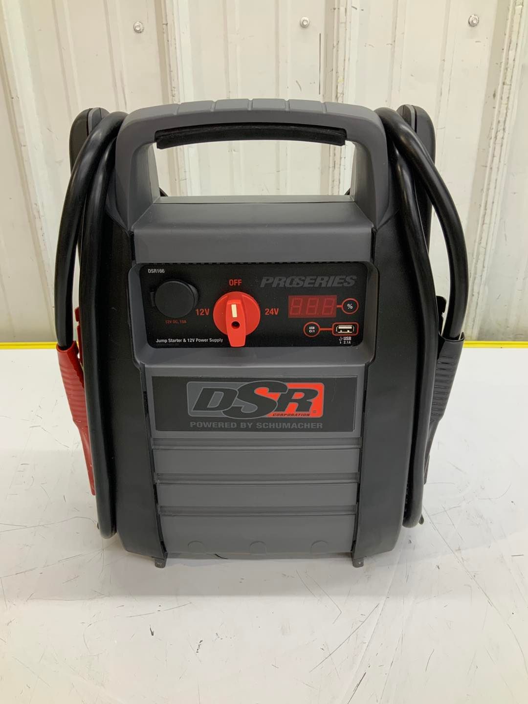 A portable battery charger is sitting on a white table.