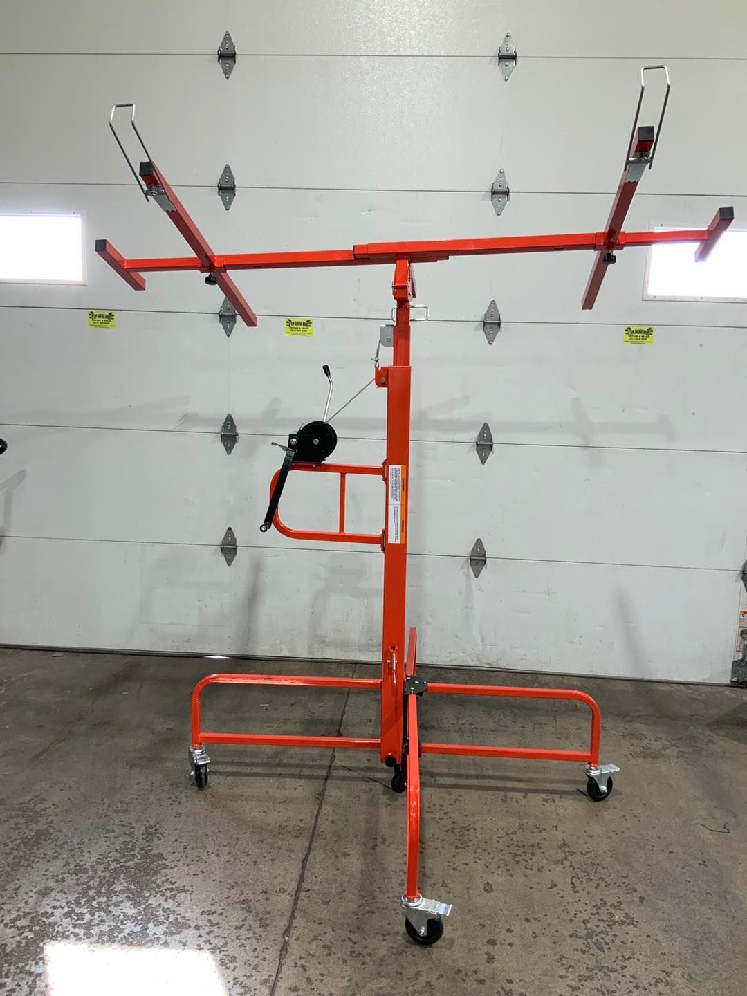 An orange stand with wheels is in front of a garage door