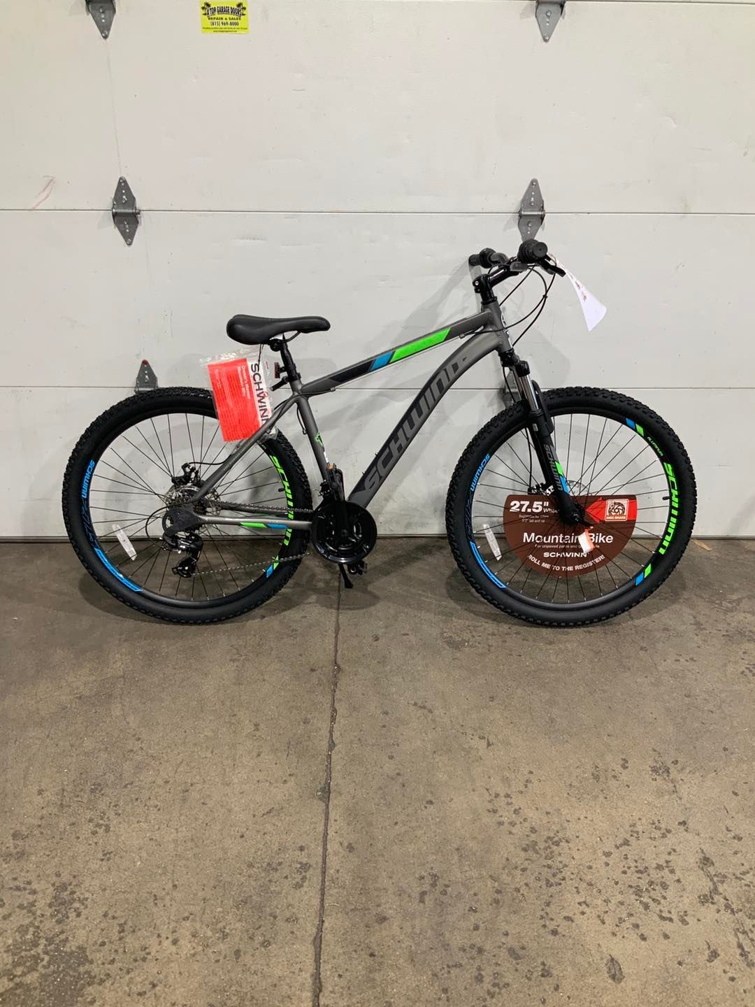 A bicycle is parked in front of a garage door.