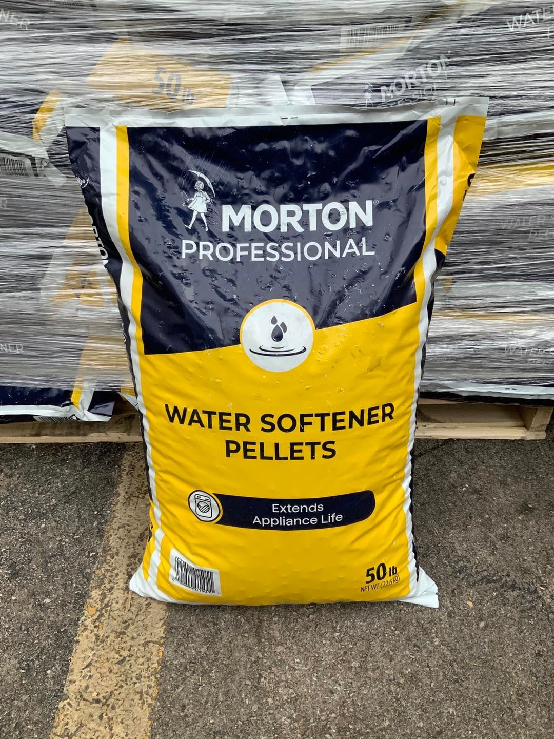 A bag of morton professional water softener pellets is sitting on top of a pallet.