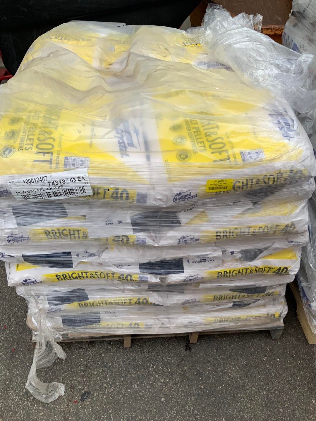 A pile of bags sitting on top of a wooden pallet.