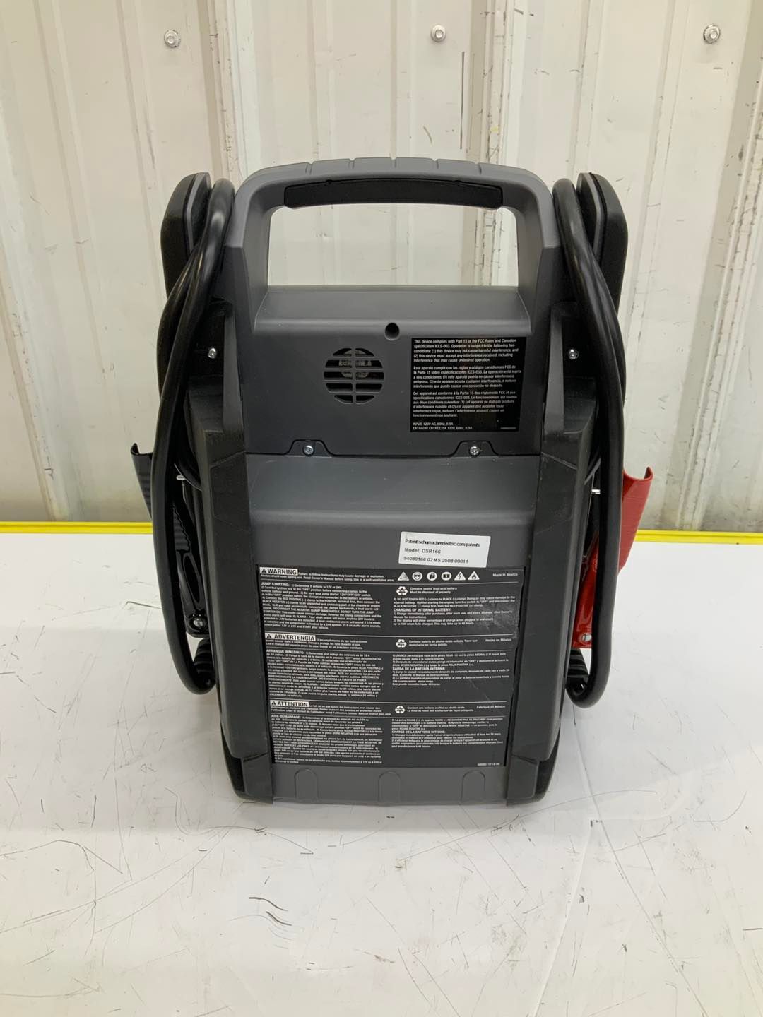 A portable battery charger is sitting on top of a white table.