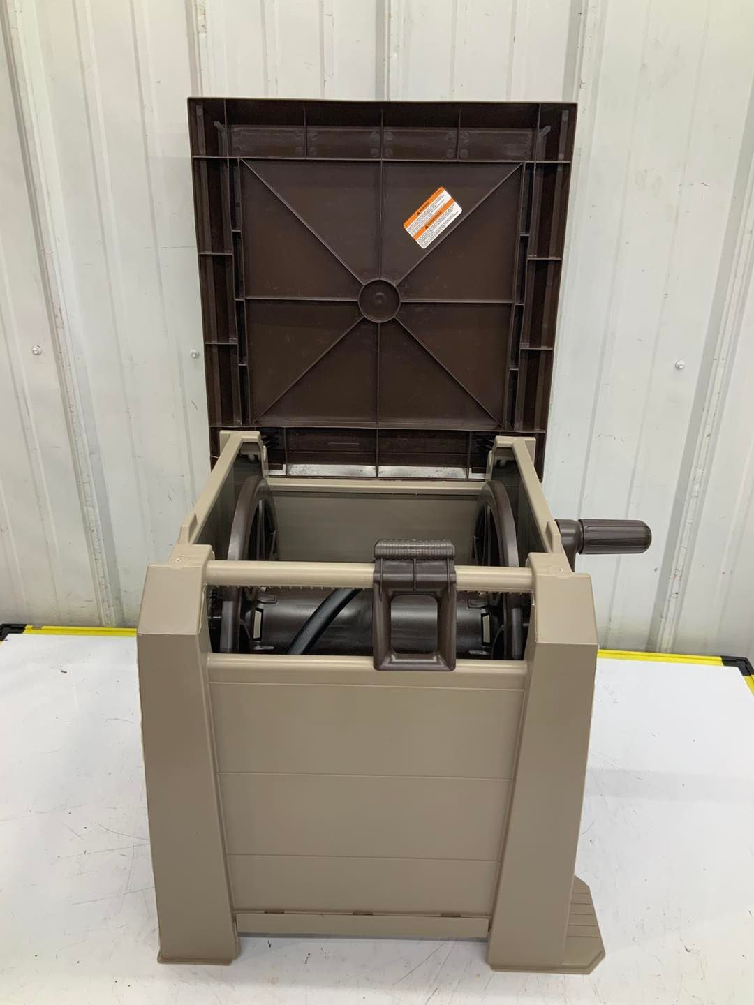 A plastic box with the lid open is sitting on a table.