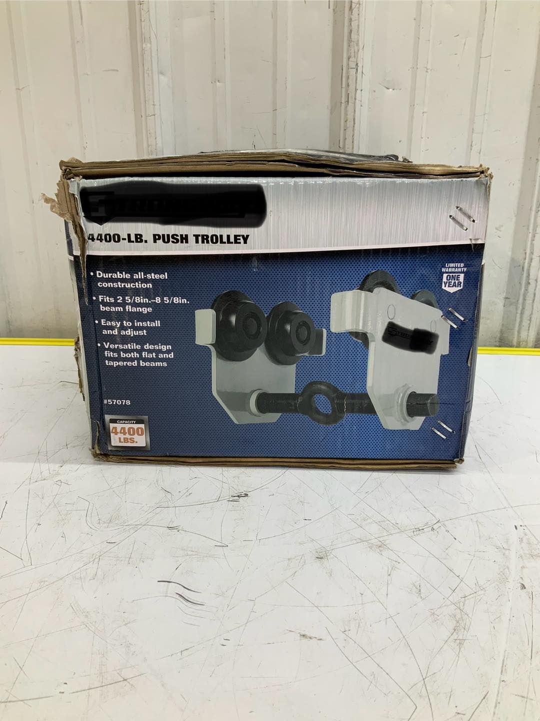 A box of a push trolley is sitting on a table.