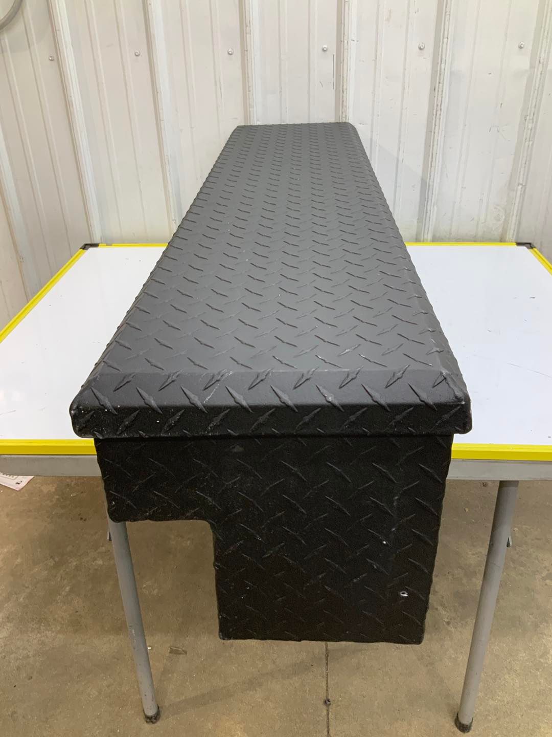 A black box is sitting on top of a white table.