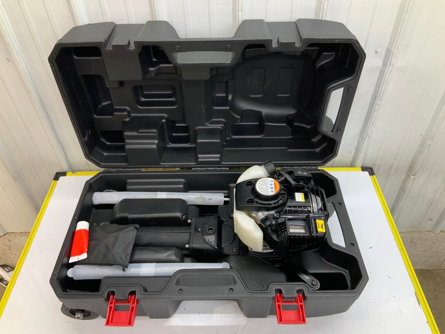 A black and red case with a tool inside of it.