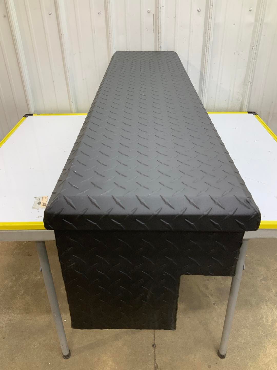 A long black table with a diamond plate top