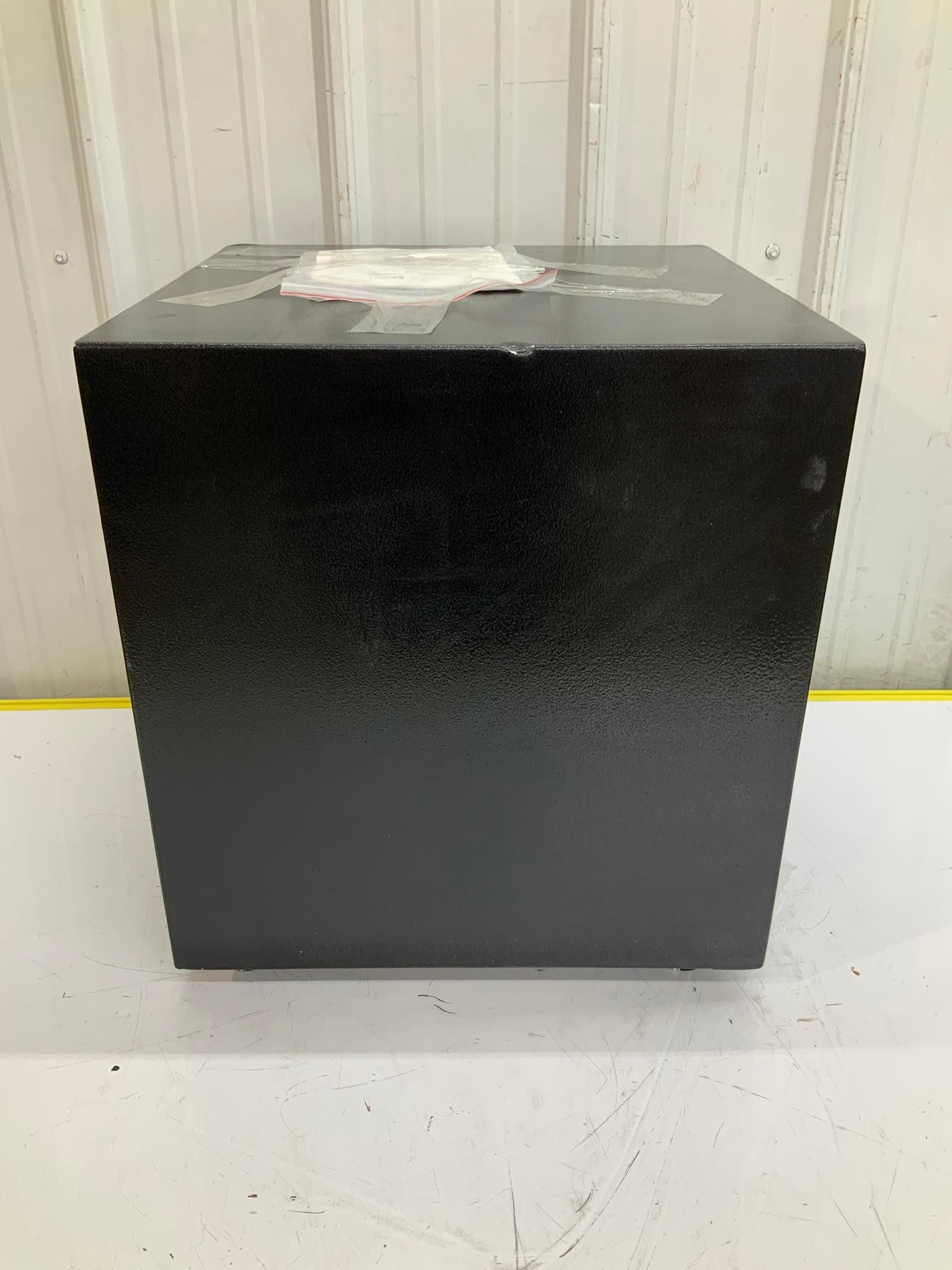 A black box is sitting on top of a white table.