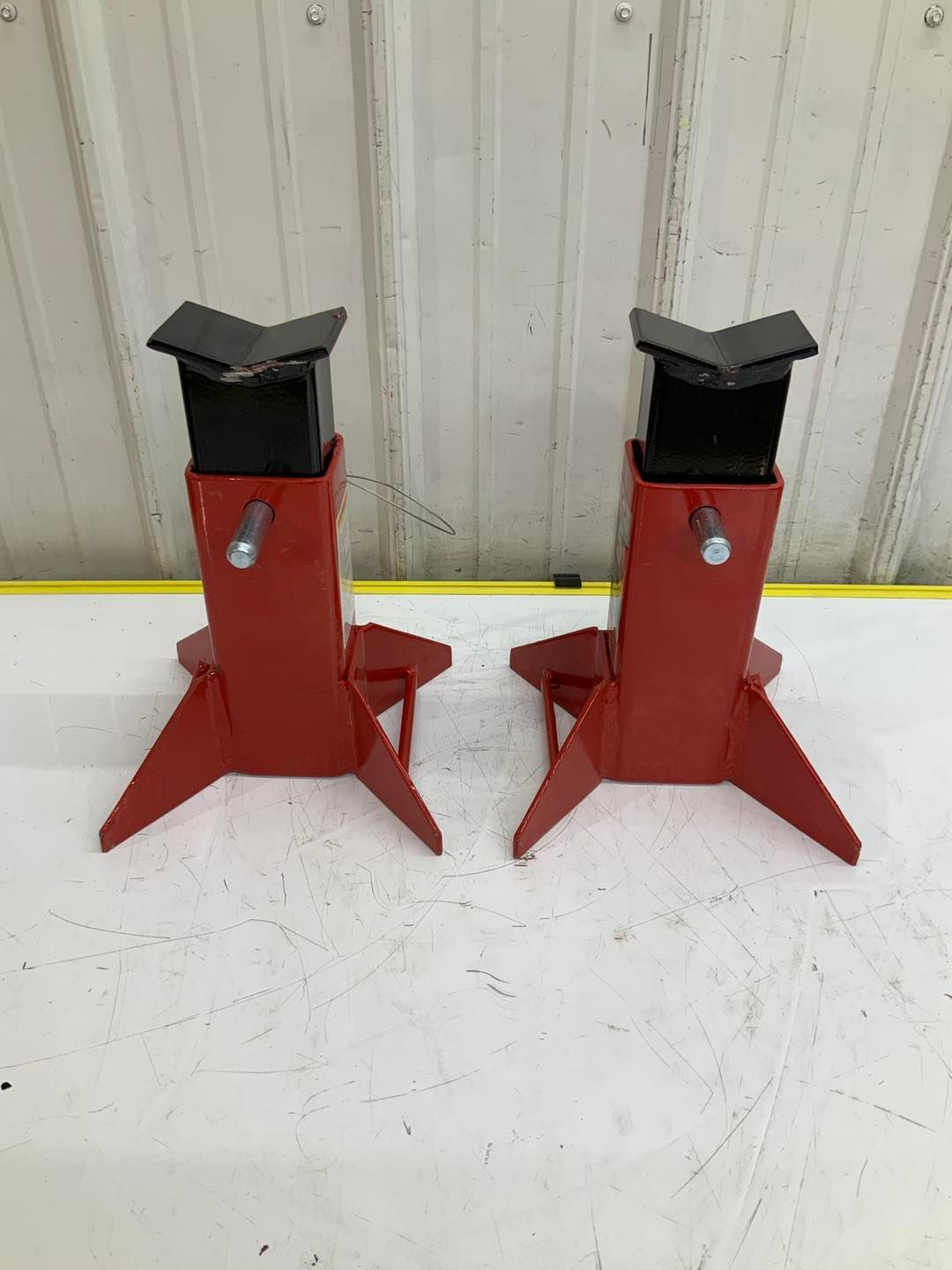 A pair of red jack stands sitting on top of a white table.