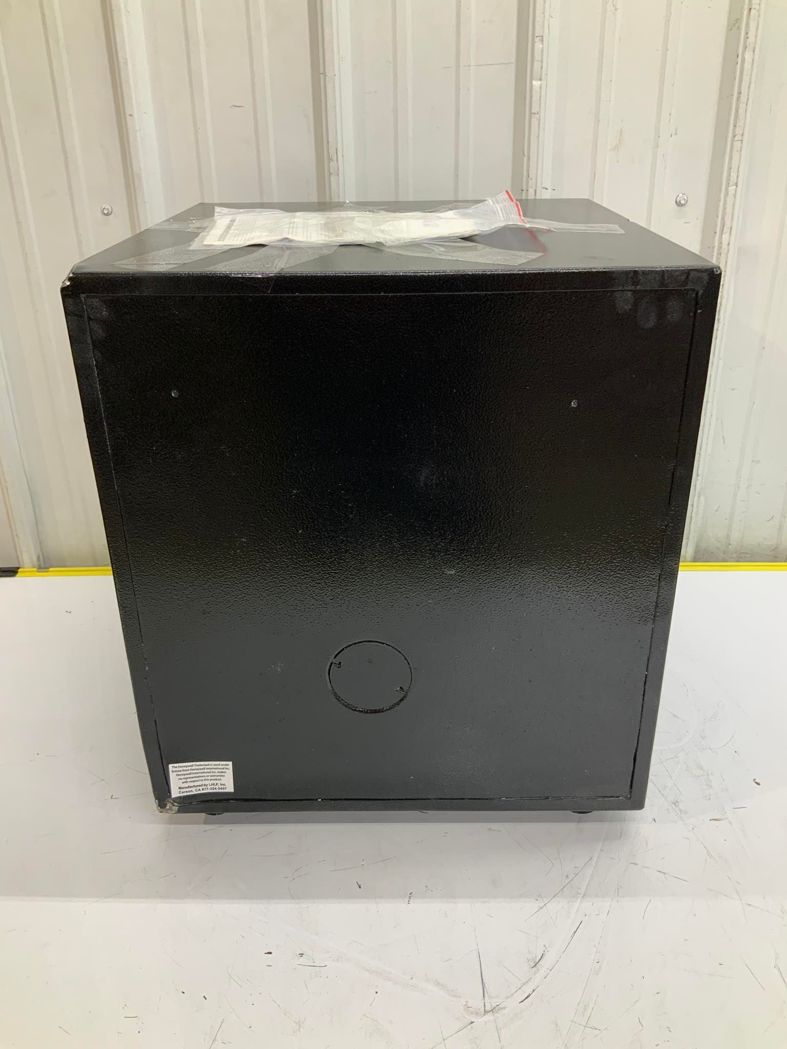 A black box is sitting on top of a white table.