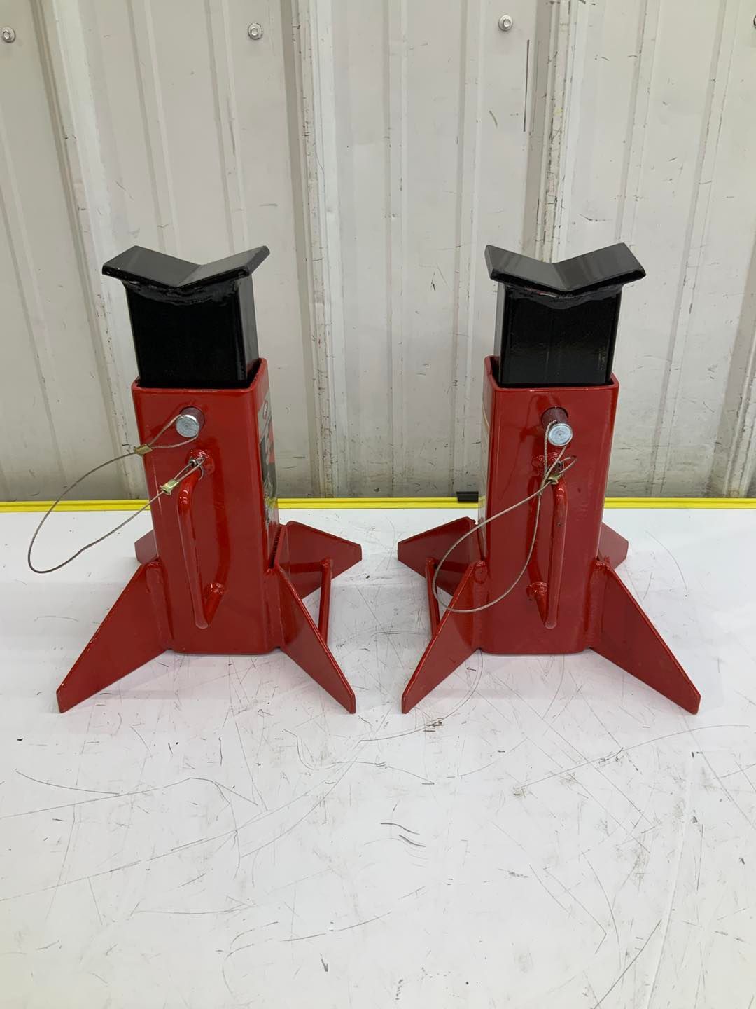 A pair of red jack stands sitting on top of a white table.