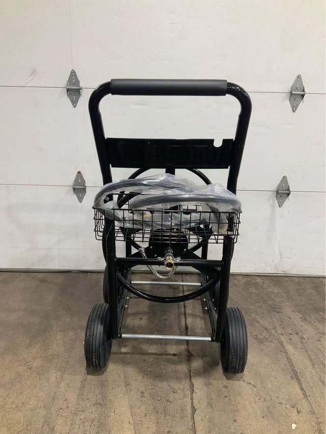 A black cart with wheels is sitting in front of a garage door.