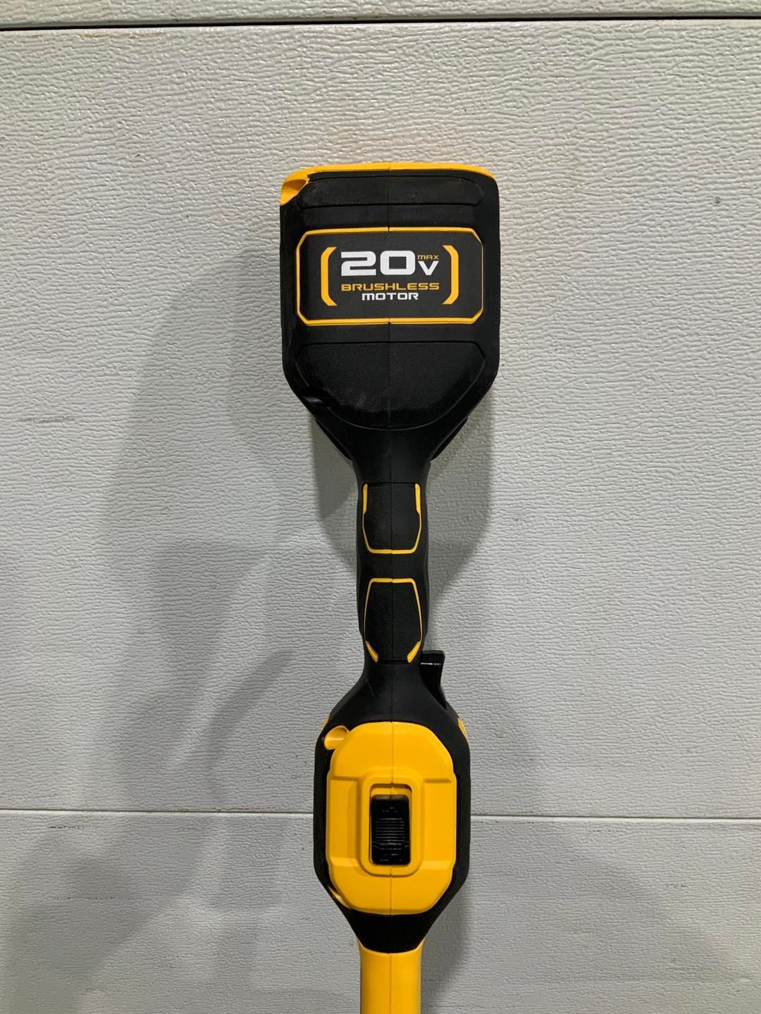 A black and yellow tool with a 20v battery attached to it.