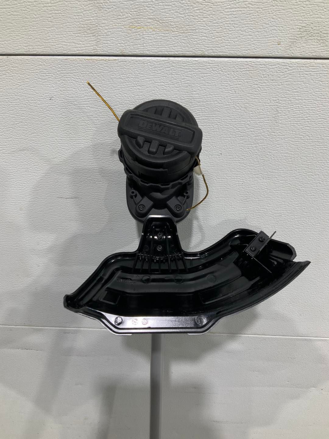 A black oil cap is sitting on top of a metal pole.