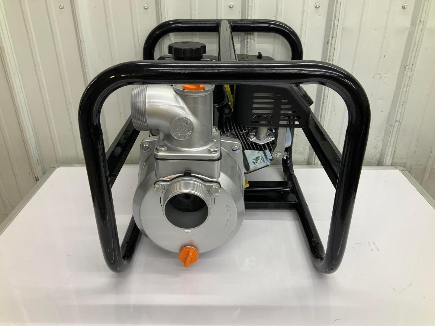 A water pump is sitting on top of a white table.