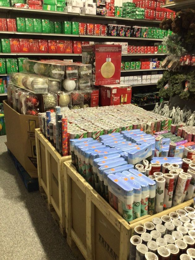 A large room filled with lots of lawn mowers and snow blowers.